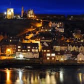 St Mary's Church and Whitby Abbey stand proud over the North Yorkshire harbour town at dusk descends. (Pic credit: Tony Johnson)