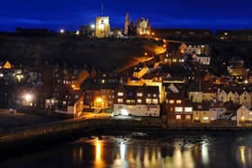 St Mary's Church and Whitby Abbey stand proud over the North Yorkshire harbour town at dusk descends. (Pic credit: Tony Johnson)