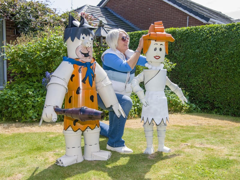 Julie Sanders sets out Fred and Wilma Flintstone made for Flamborough Flowerpot Festival 2026 running throughout June with dozens of creations around the coastal village.