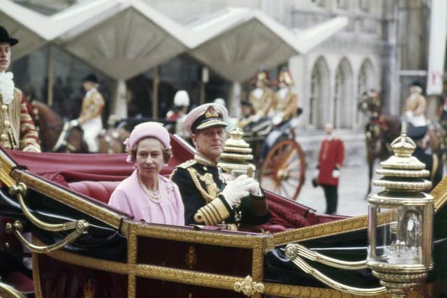 Britain's Queen Elizabeth II and Prince Philip, the Duke of Edinburgh travel in a carriage during celebrations for the Silver Jubilee in London, June 7 1977.