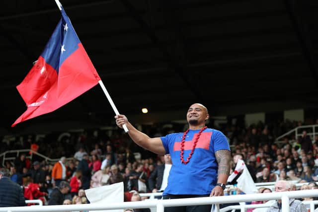 A Samoa fan shows their support with a flag prior to the opening game against England. (Photo by George Wood/Getty Images for RLWC)