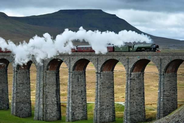 Flying Scotsman crossing the Ribblehead Viaduct in the shadow of Ingleborough in 2017. Picture by Bruce Rollinson.
