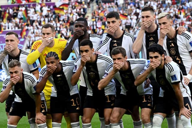 Germany's players cover their mouths as they pose for the team picture ahead of the Qatar 2022 World Cup Group E football match between Germany and Japan at the Khalifa International Stadium in Doha. (Picture: INA FASSBENDER/AFP via Getty Images)
