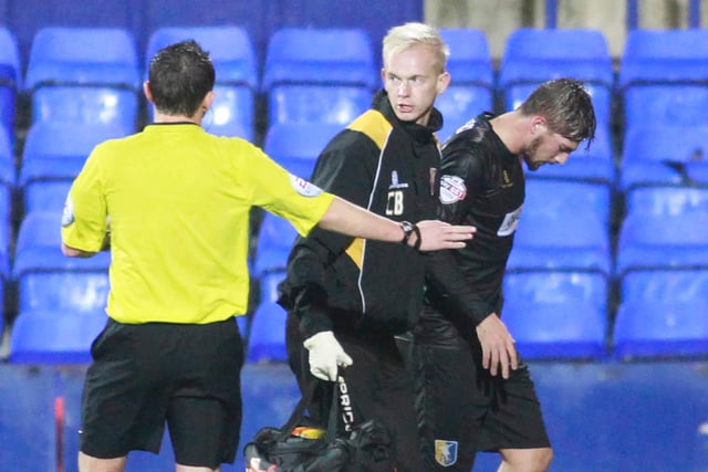 More injury woes for Mansfield as Kieron Freeman leaves the pitch with physio Chris Bowman.