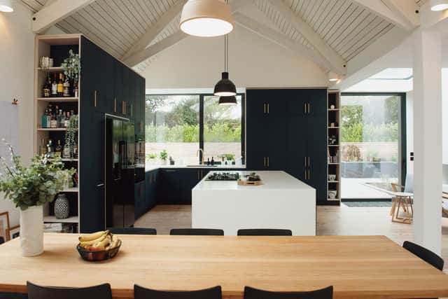 The kitchen extension with double-height ceiling plus cabinetry by Wood and Wire and pendant light by Muuto