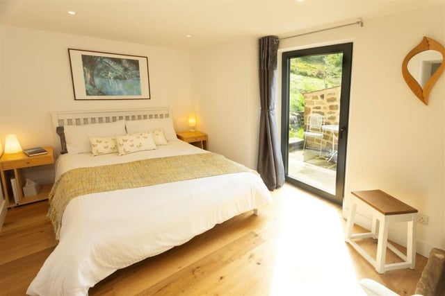 The ground floor double bedroom has a combined tilt and turn window/door opening onto a small, sheltered patio area.