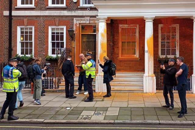 Just Stop Oil protesters demonstrating on Tufton Street by throwing orange paint on a building in London. PIC:PA/Just Stop Oil