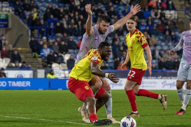 Huddersfield substitute Tyreece Simpson man-handled by Canaries captain Grant Hanley. Picture: Tony Johnson.