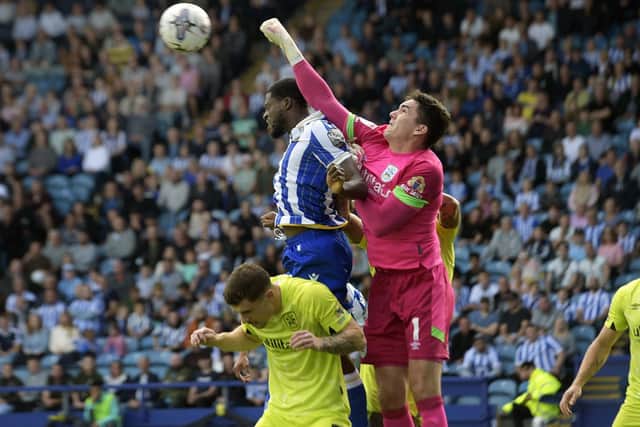 ON THE STRETCH: Huddersfield Town's Lee Nicholls punches clear of Dominic Iorfa
