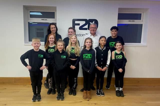 Olivia Choi (left, back row), professional dancer and teacher at Freedom 2 Dance, with Ian Short, MD of Morley Glass, with some of the budding dancers benefiting from the company’s support.
