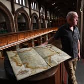 Phil Wilde is pictured with an incredibly rare copy of one of the first UK atlases ever created will be going on display at Leeds Central Library