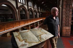 Phil Wilde is pictured with an incredibly rare copy of one of the first UK atlases ever created will be going on display at Leeds Central Library