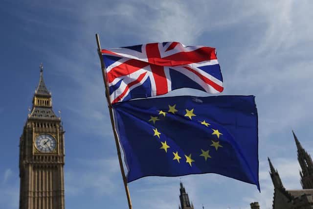 An EU flag and a Union flag outside the Houses of Parliament. PIC: DANIEL LEAL-OLIVAS/AFP via Getty Images
