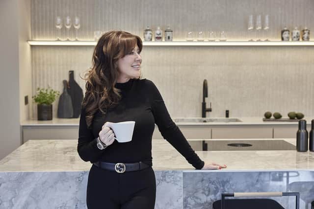 Beverley enjoying a well-earned cup of coffee after a mammoth renovation project that brought her a dream kitchen by Grid Thirteen
