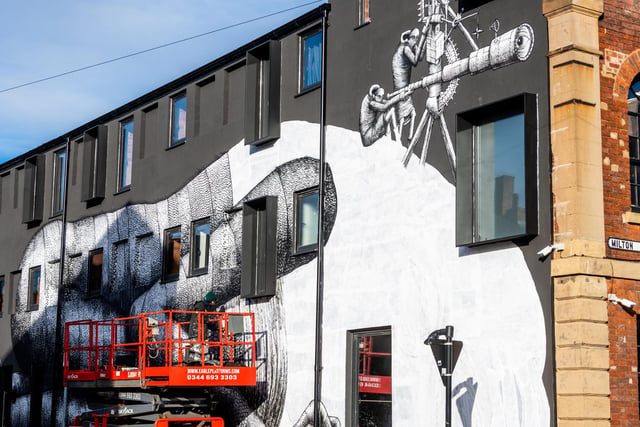 The artist is working on a massive mural on the side of the former Eye Witness Works at the junction of Hilton Street, and Headford Street in Sheffield.