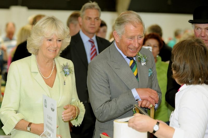 A smiling Queen Consort, Camilla , formerly Duchess of Cornwall, and Prince Charles in the cheese hall at the Great Yorkshire Showground in July 2011.