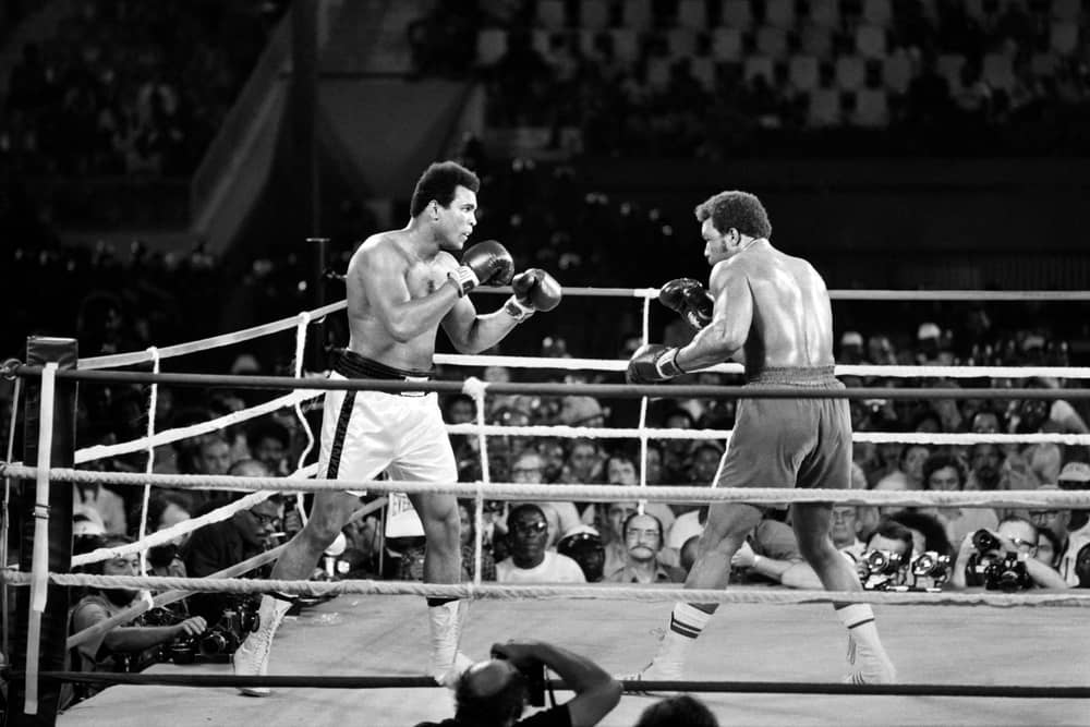 Former world heavyweight champion Muhammad Ali (L) and titleholder US George Foreman (R) fight on October 30, 1974 in Kinshasa, Zaire during their world heavyweight championship match. Ali won by knocking out Foreman in the eighth round. (Picture: AFP via Getty Images)