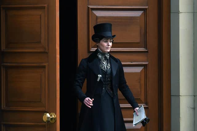 Suranne Jones wearing her black coat and top hat outfit as Anne Lister in the BBC series Gentleman Jack filming.
