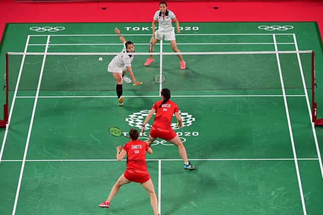 Malaysia's Lee Meng Yean (top L) hits a shot next to Malaysia's Chow Mei Kuan in their women's doubles badminton group stage match against Britain's Lauren Smith and Britain's Chloe Birch during the Tokyo 2020 Olympic Games at the Musashino Forest Sports Plaza in Tokyo on July 27, 2021. (Picture: PEDRO PARDO/AFP via Getty Images)
