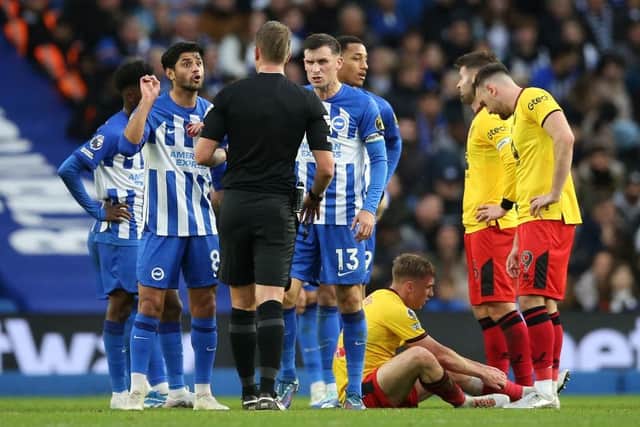 TURNING POINT: Referee John Brooks speaks to Brighton and Hove Albion midfielder Mahmoud Dahoud (left) before showing the red card
