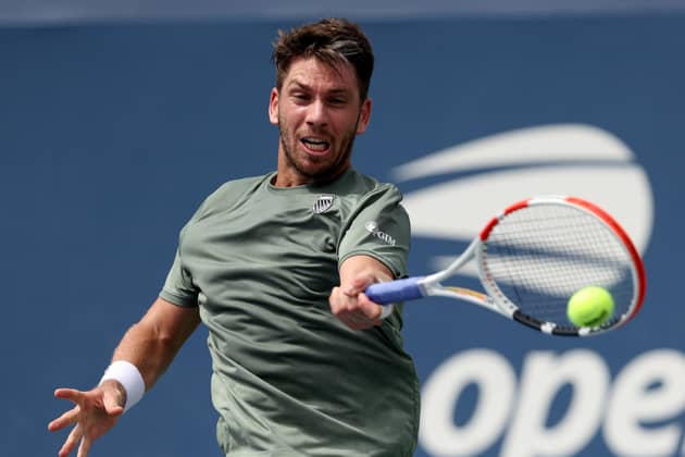 COMING THROUGH: Britain's Cameron Norrie returns a shot on his way to victory against Alexander Shevchenko during their first round singles match at the US Open Picture: Clive Brunskill/Getty Images.