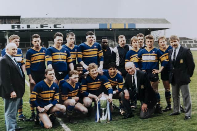 Paul (centre, holding cup), with teammates days after winning the Alliance Cup in the late 1980s.
