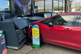 A car crashed into the M&S shop front at the petrol station.