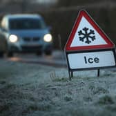 A warning triangle alerts drivers to an icy road. (Pic credit: Christopher Furlong / Getty Images)