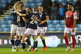 Tom Bradshaw of Millwall (C) celebrates with teammates after scoring the team's third goal  during the Sky Bet Championship match between Millwall and Rotherham United at The Den on September 20, 2023 in London, England. (Photo by Andrew Redington/Getty Images)