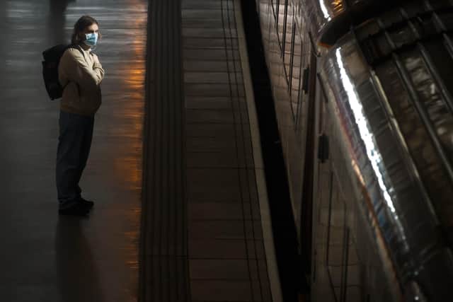 A man wears a face mask at Leeds station, at the height of the pandemic. PIC: Danny Lawson/PA Wire