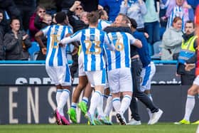 Huddersfield Town players and staff, including head coach Andre Breitenreiter, celebrate their late winner versus Millwall. Picture Bruce Rollinson