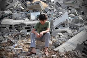 A Palestinian child boy next to the ruins of a building in Gaza City that was hit by a rocket. PIC: DOAA ALBAZ/Middle East Images/AFP via Getty Images