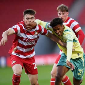 Doncaster Rovers and Ireland under-21 defender Sean Grehan takes on Huddersfield Town's Jay Sway in the EFL Trophy game last month. Picture: Jonathan Gawthorpe