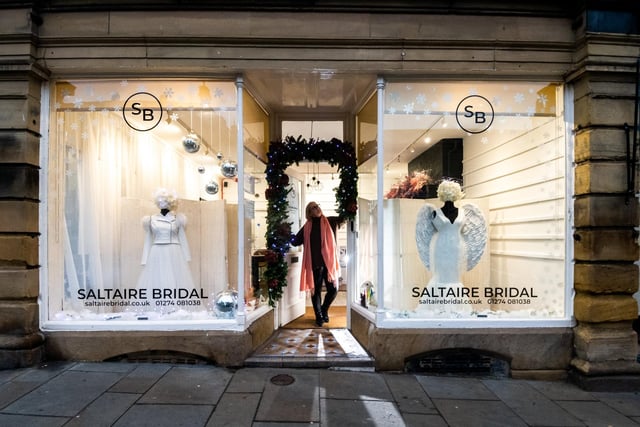 Pictured Tracy Butterfield, owner Saltaire Bridal, finishing her window display before the switch on.