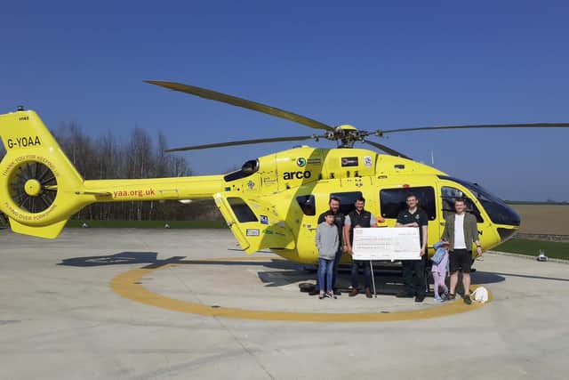 Benjamin Patel presenting the  team from YAA with his fundraising cheque