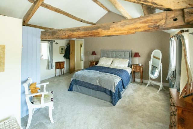 One of the bedrooms open to the original beams