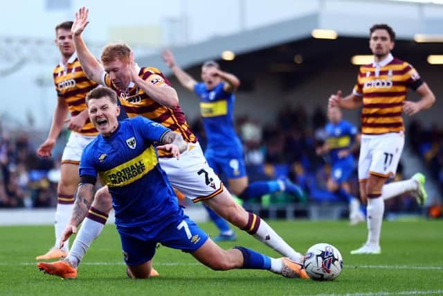 LUCKY ESCAPE: Bradford City escaped penalty appeals after Brad Halliday's penalty-area tackle on James Tilley