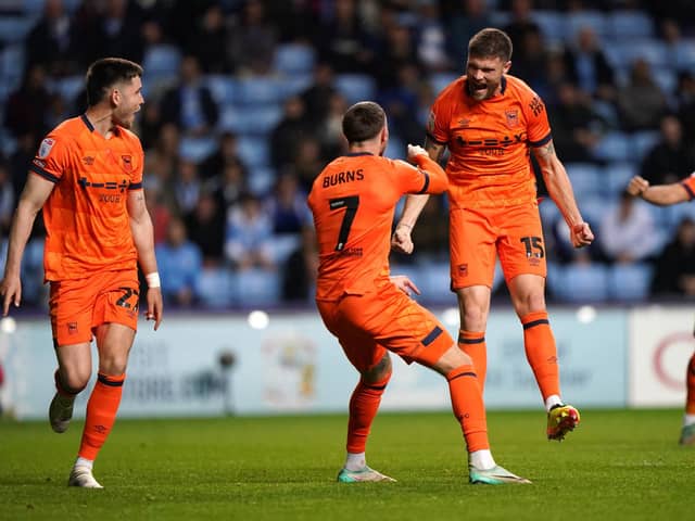 Ipswich Towns' Cameron Burgess (second right) celebrates scoring their side's winning goal at Coventry. (Picture: PA)
