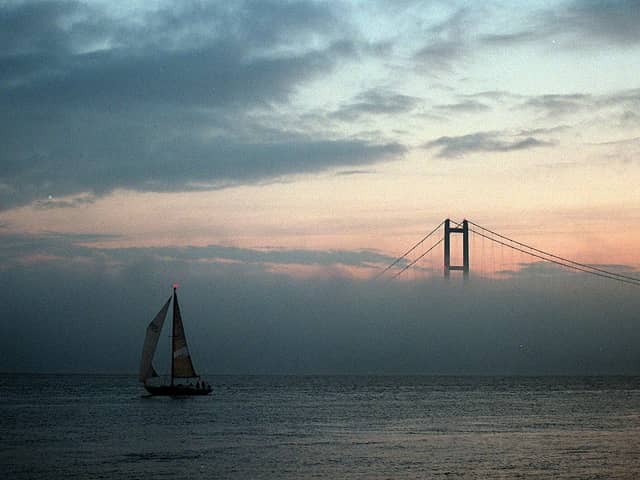 A yacht makes its way down the River Humber as a late autumn fog bank shrouds the lower half of the Humber Bridge. Picture: John Jones
