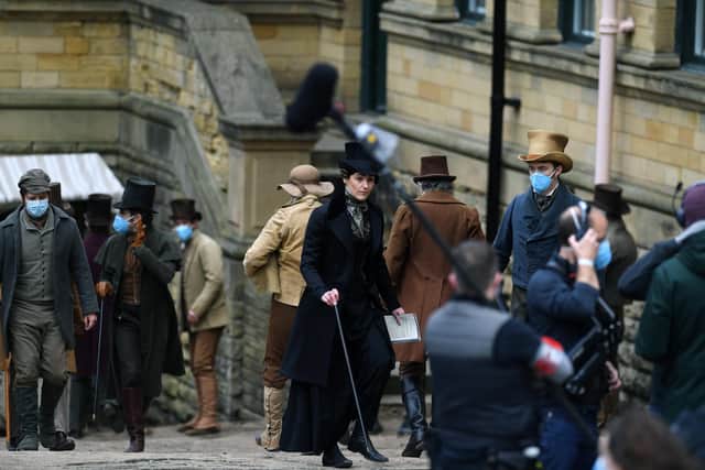 Suranne Jones wearing her iconic black coat and top hat outfit as Anne Lister in the BBC series Gentleman Jack filming at Salts Mill in Saltaire.
13th April March 2021. Picture : Jonathan Gawthorpe