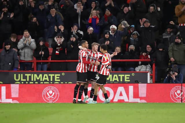 Sheffield United's Tommy Doyle (centre) celebrates with teammates after scoring their side's third goal of the game during the Sky Bet Championship match at Bramall Lane, Sheffield. Picture date: Monday December 26, 2022. Picture: Isaac Parkin/PA Wire.