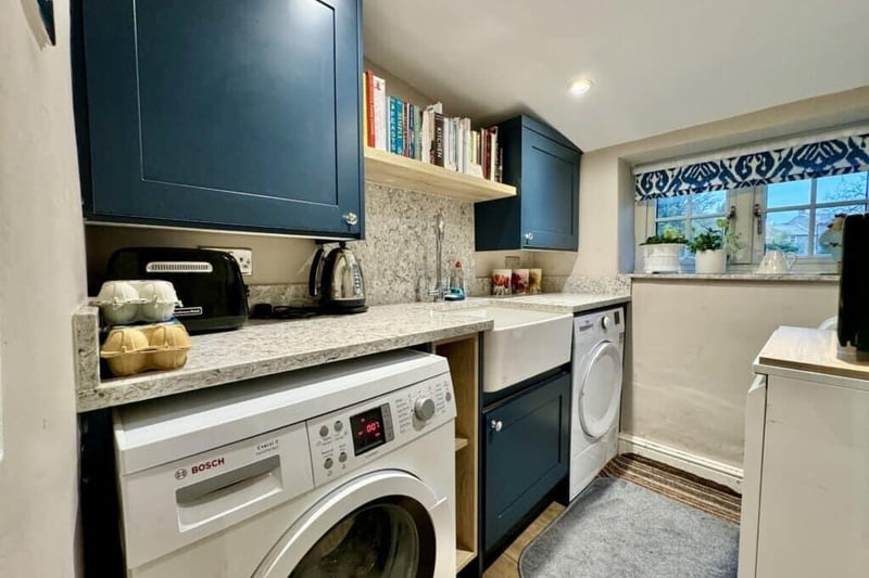 The utility room with space for washer, dryer and a mini kitchen/larder