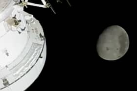 In this image from video provided by NASA, the Moon is seen from a camera outside the Orion Spacecraft after the Artemis II astronauts surpassed the farthest distance ever traveled by humans from Earth, Monday, April 6, 2026. (NASA via AP)