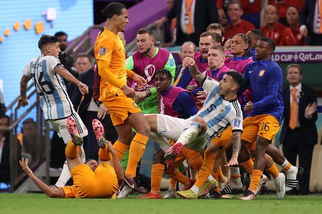 Virgil Van Dijk of Netherlands clashes with Leandro Paredes of Argentina after the latter had kicked the ball into the Dutch dugout. (Picture: Julian Finney/Getty Images)