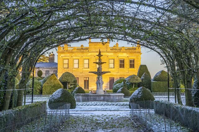 Late winter sunshine casts a golden sheen onto Brodsworth Hall near Doncaster amidst a dusting of snow.  Picture Tony Johnson