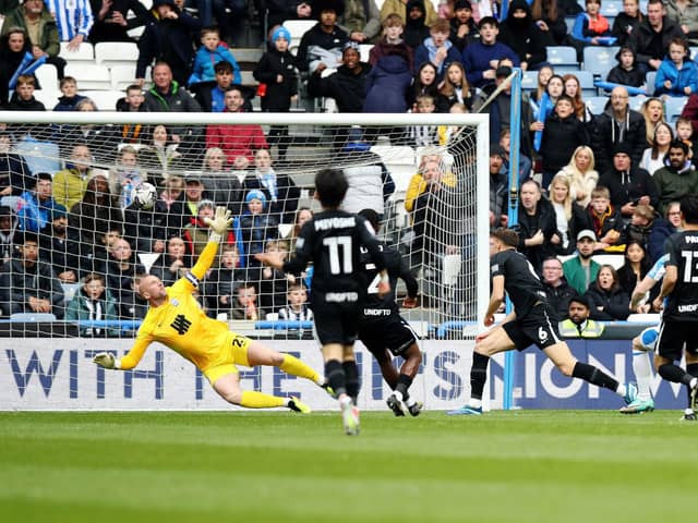 Huddersfield Town's Rhys Healey (obscured) scores their side's leveller during the Sky Bet Championship match versus Birmingham City at the John Smith's Stadium. Picture: Jess Hornby/PA Wire.
