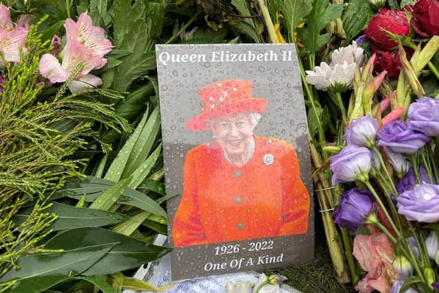 Floral tributes at Hillsborough Castle following the death of Queen Elizabeth II. Pic credit: Jonathan McCambridge / PA)