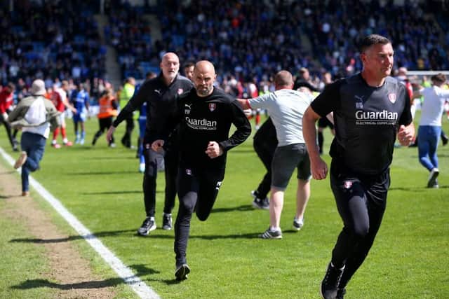 CELEBRATIONS SPOILT: Then-Rotherham United manager Paul Warne (centre) and his coaching staff run down the tunnel as fans invade the pitch at Gillingham