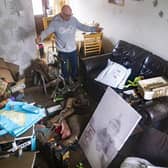 David Pickering inspects flood damage in his home in Catcliffe near Rotherham.
