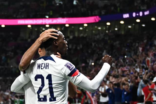 USA's forward #21 Timothy Weah celebrates his goal in the 1-1 draw with Wales that sets up Friday's clash with England (Picture: Jewel SAMAD / AFP via Getty Images)